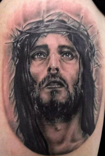 Tatuaje en el brazo, cara de Jesús