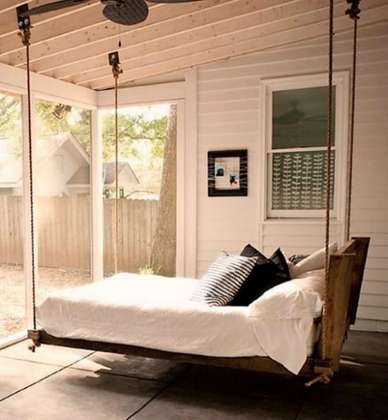 מיטה תלויה מחוץ לדגם פשוט במרפסת נראית מאוד רומנטית ומזמינה