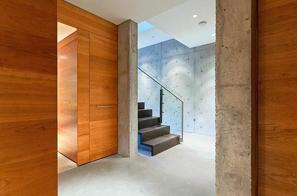מדרגות עיצוב קיר בטון מעקה זכוכית בטון חשוף בבית