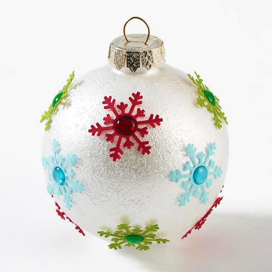 כדור פח של קישוט חג המולד עם פתיתי שלג קטנים וצבעוניים